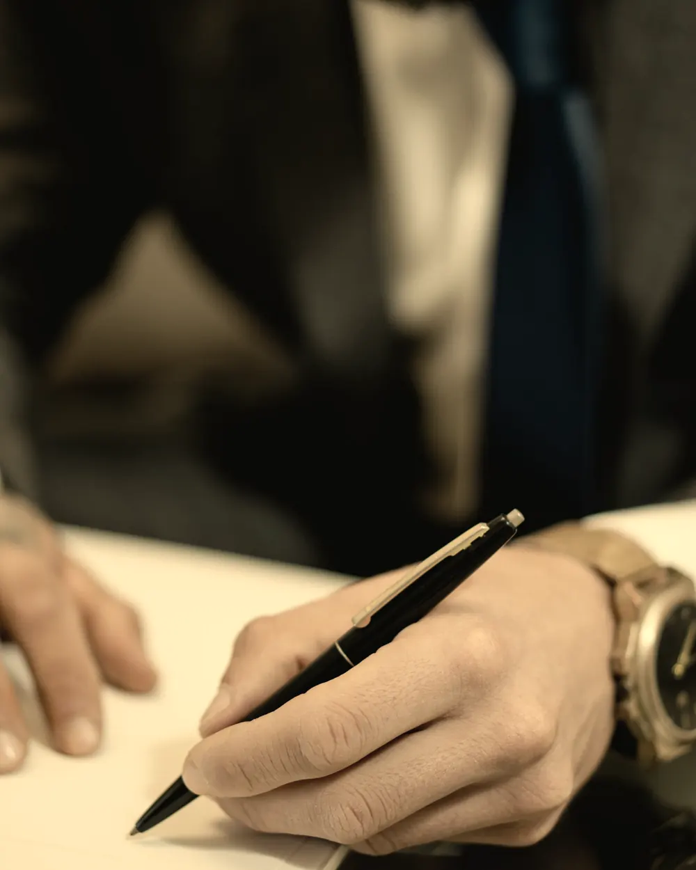 An attorney reviewing and signing a document